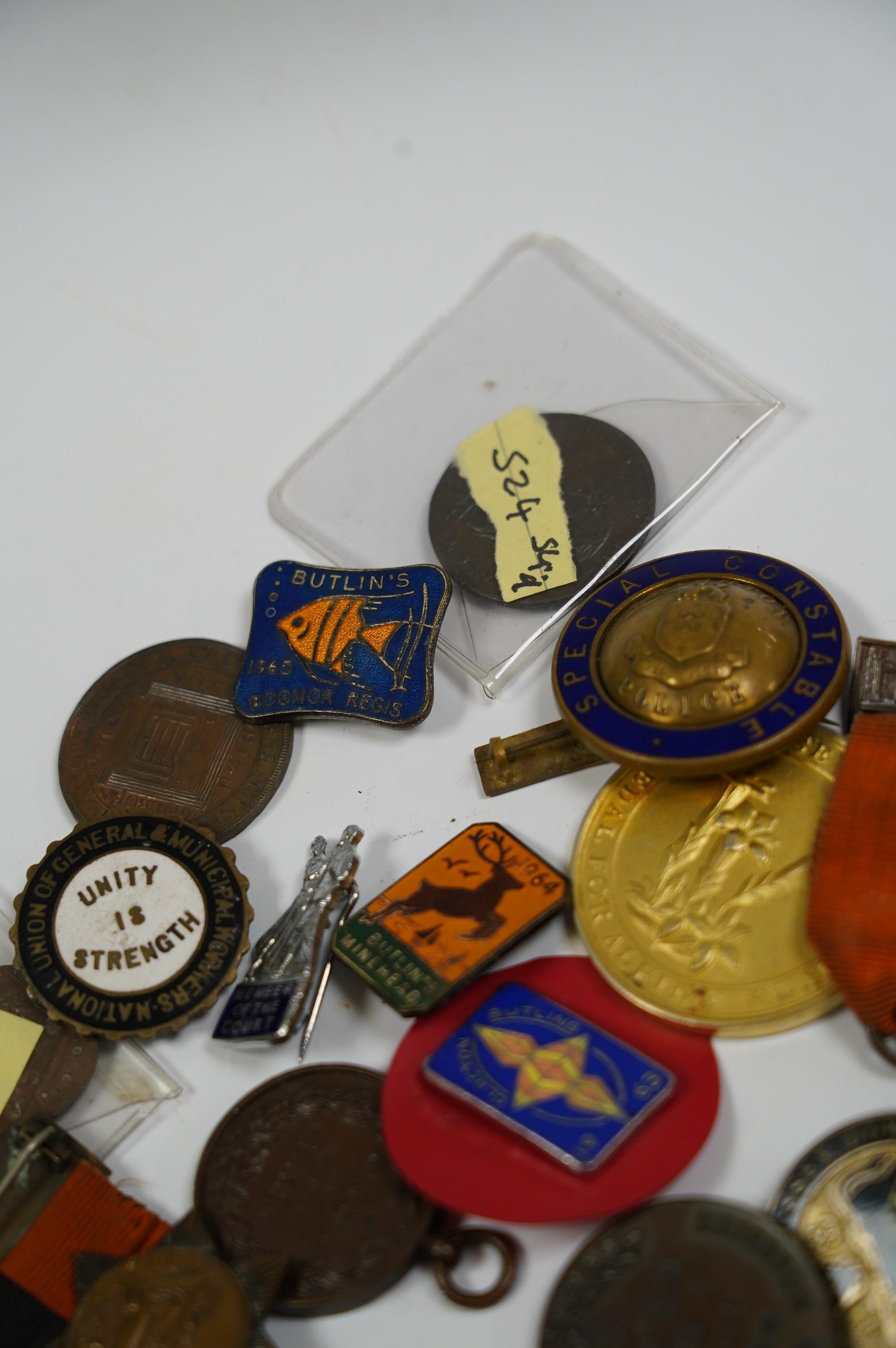 A group of assorted tokens, medallions and badges